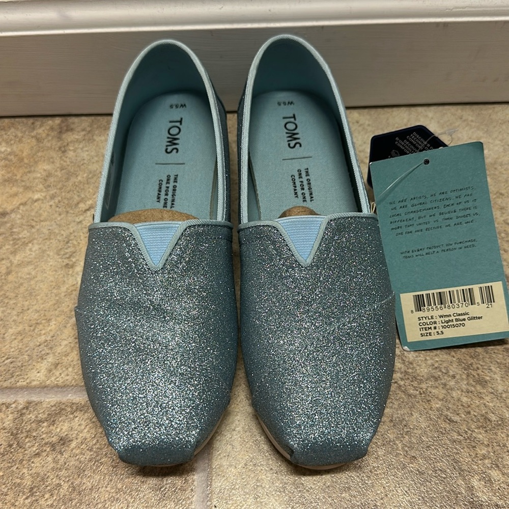 Blue sparkly women’s Tom’s. Size 5.5. Never worn. Comes with box.